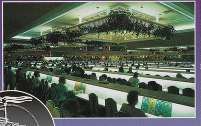 A 1990s postcard panel of the Showboat bingo parlor: rows of players at long lit tables with green and yellow bingo cards, overhead flashboards glowing