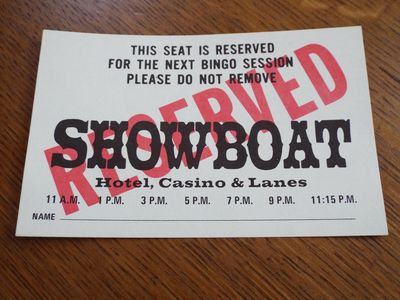 A printed Showboat bingo seat reservation card reading This Seat Is Reserved For The Next Bingo Session, with session times from 11 a.m. to 11:15 p.m.