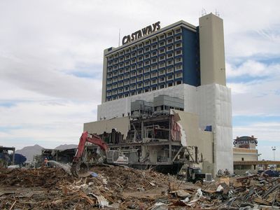 The empty Castaways hotel tower standing behind demolition debris where the casino low-rise had been