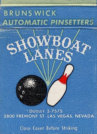 The front panel of a powder-blue Showboat Lanes matchbook: a black bowling ball and white pin over rays, with Brunswick Automatic Pinsetters, DUdley 2-7575, and 2800 Fremont St. Las Vegas, Nevada